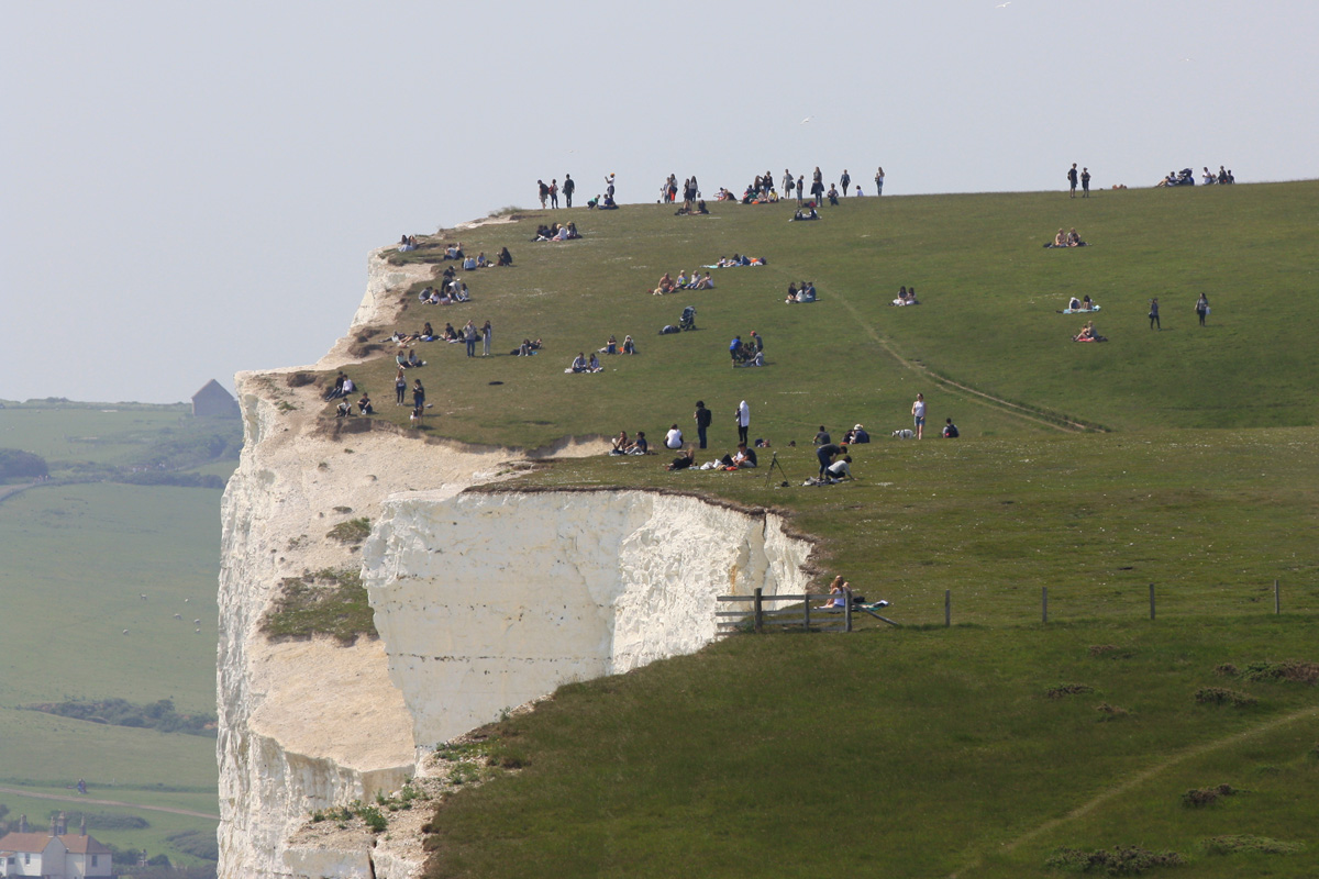 Lots of people very near the cliff edge at the Seven Sisters